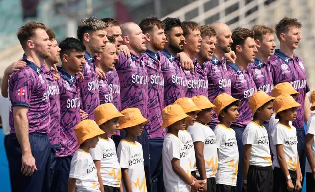 Scotland players stand for the national anthems of the respective countries before the start of the T20 World Cup cricket match between them in Kolkata, India, Monday, Feb. 9, 2026. (AP Photo/Bikas Das)