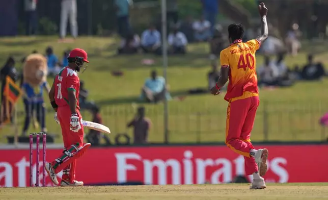 Zimbabwe's Blessing Muzarabani, right, celebrates the wicket of Oman's Karan Sonavale during the T20 World Cup cricket match between Oman and Zimbabwe in Colombo, Sri Lanka, Monday, Feb. 9, 2026. (AP Photo/Eranga Jayawardena)
