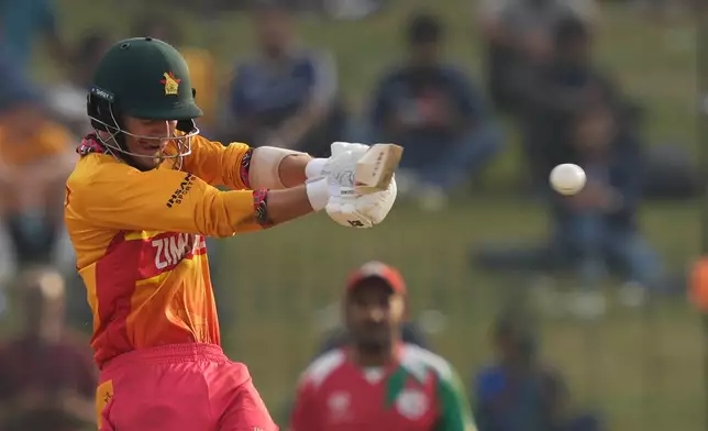 Zimbabwe's Brian Bennett hits a boundary during the T20 World Cup cricket match between Oman and Zimbabwe in Colombo, Sri Lanka, Monday, Feb. 9, 2026. (AP Photo/Eranga Jayawardena)