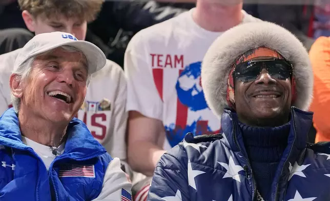 Snoop dog and five-time olympic gold medallist former speed skater Eric Heiden of the U.S. watch the men's 1,000 meters speedskating race at the 2026 Winter Olympics, in Milan, Italy, Wednesday, Feb. 11, 2026. (AP Photo/Ben Curtis)