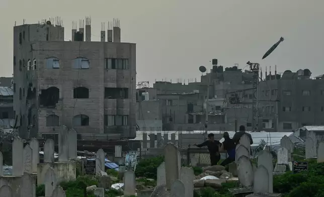 A bomb flies in the air as it approaches a building during an Israeli military strike in the Zeitoun neighborhood of Gaza City, Friday, Feb. 6, 2026. (AP Photo/Jehad Alshrafi)