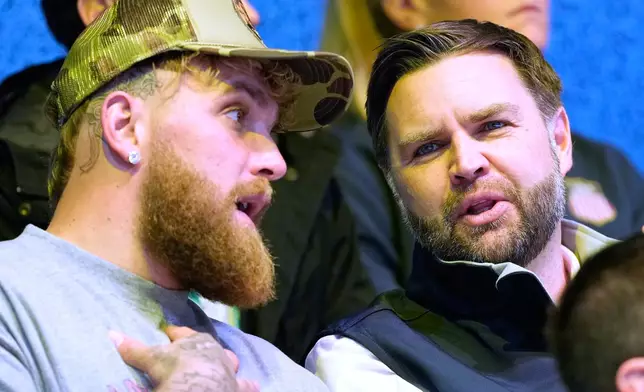 Jake Paul, left, and Vice President JD Vance attend a preliminary round match of women's ice hockey between the United States and Finland at the 2026 Winter Olympics, in Milan, Italy, Saturday, Feb. 7, 2026. (AP Photo/Petr David Josek)