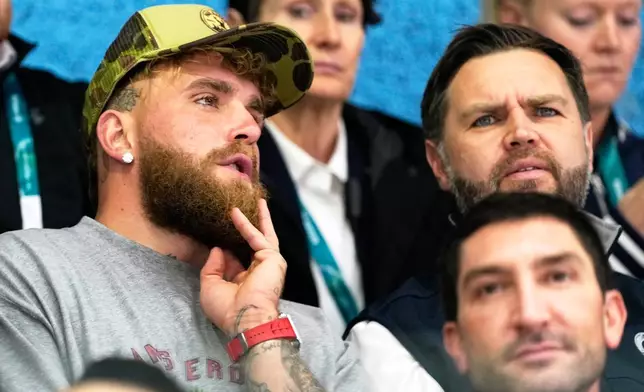 Jake Paul, left, and Vice President JD Vance attend a preliminary round match of women's ice hockey between the United States and Finland at the 2026 Winter Olympics, in Milan, Italy, Saturday, Feb. 7, 2026. (AP Photo/Petr David Josek)