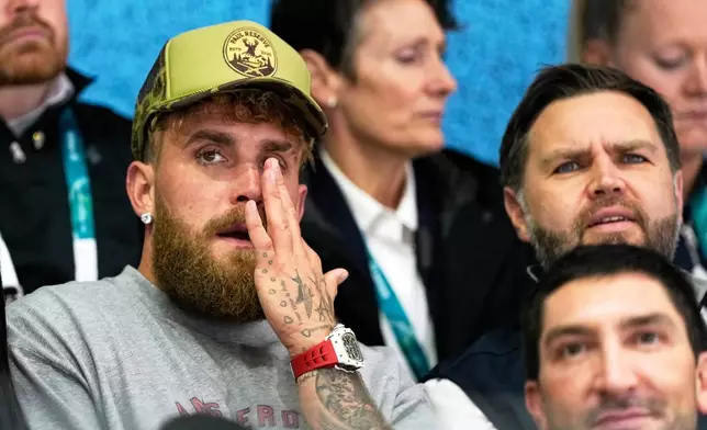 Jake Paul, left, and Vice President JD Vance attend a preliminary round match of women's ice hockey between the United States and Finland at the 2026 Winter Olympics, in Milan, Italy, Saturday, Feb. 7, 2026. (AP Photo/Petr David Josek)