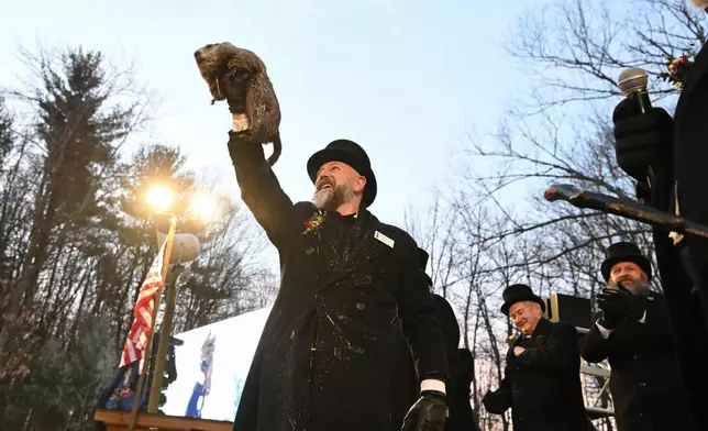FILE - Groundhog Club handler A.J. Dereume holds Punxsutawney Phil, the weather prognosticating groundhog, during the 139th celebration of Groundhog Day on Gobbler's Knob in Punxsutawney, Pa., Feb. 2, 2025. (AP Photo/Barry Reeger, File)