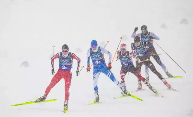 Jens Luraas Oftebro, of Norway, from left, Eero Hirvonen, of Finland, Johannes Lamparter, of Austria, Vinzenz Geiger, of Germany, and Ryota Yamamoto, of Japan, compete in the nordic combined team sprint at the 2026 Winter Olympics, in Tesero, Italy, Thursday, Feb. 19, 2026. (AP Photo/Evgeniy Maloletka)
