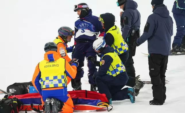 Medics respond after United States' Nick Goepper crashed during the men's freestyle skiing halfpipe finals at the 2026 Winter Olympics, in Livigno, Italy, Friday, Feb. 20, 2026. (AP Photo/Lindsey Wasson)