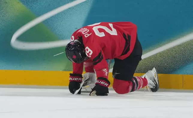 Canada's Marie-Philip Poulin (29) is down on the ice in the first period against Czechia during a preliminary round match of women's ice hockey at the 2026 Winter Olympics, in Milan, Italy, Monday, Feb. 9, 2026. (AP Photo/Carolyn Kaster)