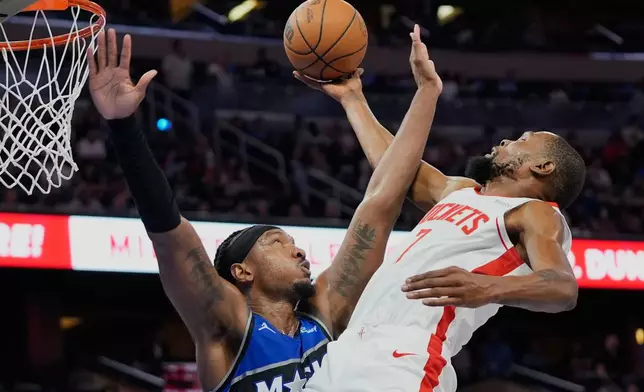 Houston Rockets forward Kevin Durant, right, goes to the basket against Orlando Magic center Wendell Carter Jr. during the second half of an NBA basketball game, Thursday, Feb. 26, 2026, in Orlando, Fla. (AP Photo/John Raoux)
