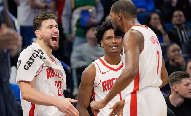 Houston Rockets forward Kevin Durant (7) celebrates with teammates center Alperen Sengun (28) and guard Amen Thompson, center, after making a shot after he was fouled during the second half of an NBA basketball game against the Orlando Magic, Thursday, Feb. 26, 2026, in Orlando, Fla. (AP Photo/John Raoux)