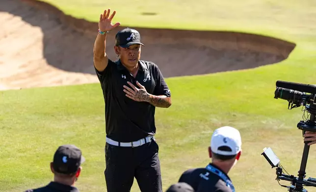 Anthony Kim of 4Aces GC waves to the fans after winning first place during the final round of the LIV Golf Adelaide at Grange Golf Club in Adelaide, Australia Sunday, Feb. 15, 2026. (Pedro Salado/LIV Golf via AP)