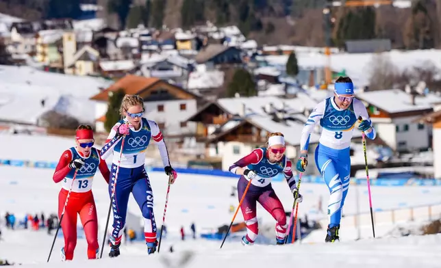 Kerttu Niskanen, of Finland, from right, Teresa Stadlober, of Austria, Jessie Diggins, of the United States, and Nadja Kaelin, of Switzerland, compete in the cross country skiing women's 50km mass start classic at the 2026 Winter Olympics, in Tesero, Italy, Sunday, Feb. 22, 2026. (AP Photo/Kirsty Wigglesworth)