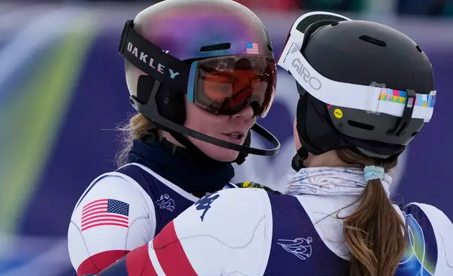 United States' Mikaela Shiffrin, left, is hugged by United States' Paula Moltzan at the finish area of an alpine ski, women's team combined race, at the 2026 Winter Olympics, in Cortina d'Ampezzo, Italy, Tuesday, Feb. 10, 2026. (AP Photo/Andy Wong)