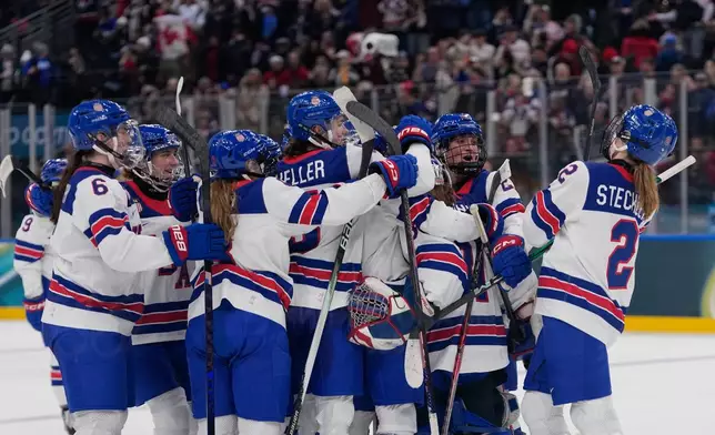 US players celebrate at the end of a preliminary round match of women's ice hockey between USA and Canada at the 2026 Winter Olympics, in Milan, Italy, Tuesday, Feb. 10, 2026. (AP Photo/Petr David Josek)