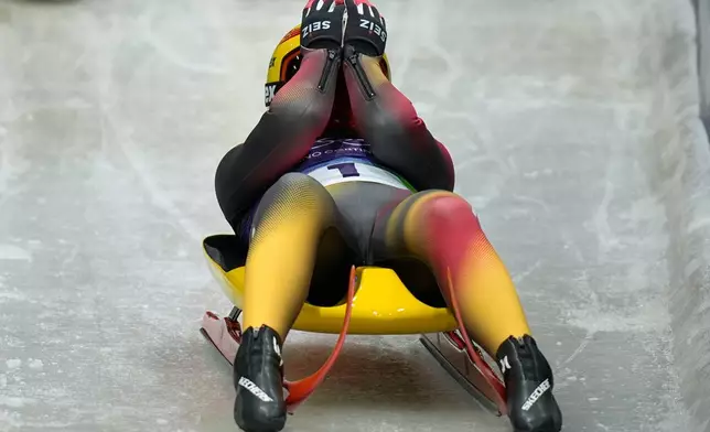 Germany's Julia Taubitz celebrates winning the gold medal during a women's single luge competition at the 2026 Winter Olympics, in Cortina d'Ampezzo, Italy, Tuesday, Feb. 10, 2026. (AP Photo/Aijaz Rahi)