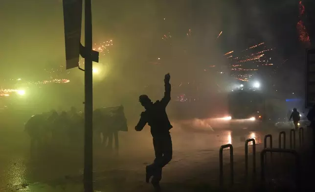 Demonstrators clash with police during a protest against the Milan-Cortina 2026 Olympics, in Milan, Italy, Saturday Feb. 7, 2026. (Claudio Furlan/LaPresse via AP)