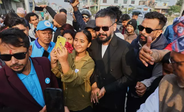 Former Kathmandu Mayor Balendra Shah, center right, the prime ministerial candidate of the Rastriya Swatantra Party, meets supporters during an election campaign rally in Jhapa, Nepal, Monday, Feb. 23, 2026. (AP Photo/Umesh Karki)