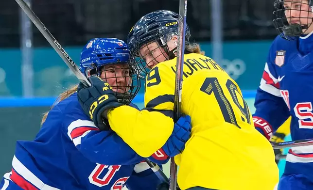 United States' Haley Winn, left, collides with Sweden's Sara Hjalmarsson during a semifinal match of women's ice hockey between the United States and Sweden at the 2026 Winter Olympics, in Milan, Italy, Monday, Feb. 16, 2026. (AP Photo/Petr David Josek)