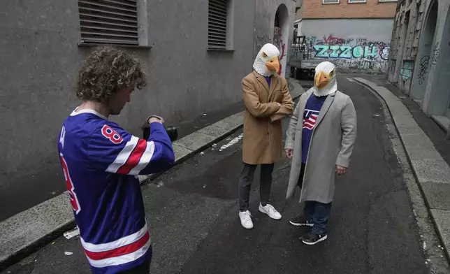 Ryan Winn films Casey Winn and Mitchell Hanson in a promotional video for the Winn's sister, Haley Winn, and the rest of the USA women's hockey team, Thursday, Feb. 19, 2026, in Milan, Italy. (AP Photo/Brittany Peterson)