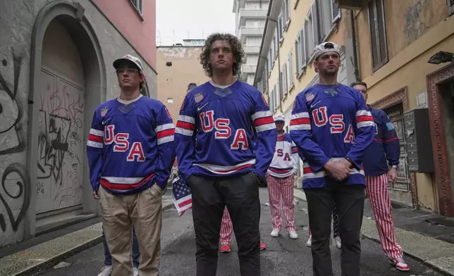 Tommy, Ryan and Casey Winn, brothers of USA Hockey player Haley Winn, film a video to promote women's hockey, Thursday, Feb. 19, 2026, in Milan, Italy. (AP Photo/Brittany Peterson)