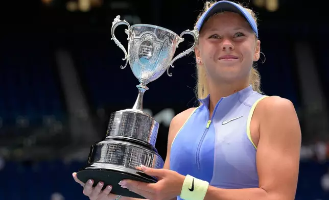 Ksenia Efremova of France holds her trophy after defeating Ekaterina Tupitsyna of Russia in the girl's singles final at the Australian Open tennis championship in Melbourne, Australia, Sunday, Feb. 1, 2026. (AP Photo/Dar Yasin)
