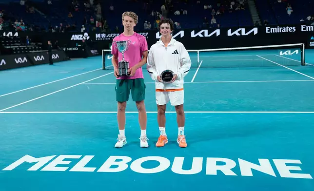 Ziga Sesko, left, of Slovenia poses with his trophy after defeating Keaton Hance, right, of the U.S. in the boy's singles final at the Australian Open tennis championship in Melbourne, Australia, Sunday, Feb. 1, 2026. (AP Photo/Dar Yasin)