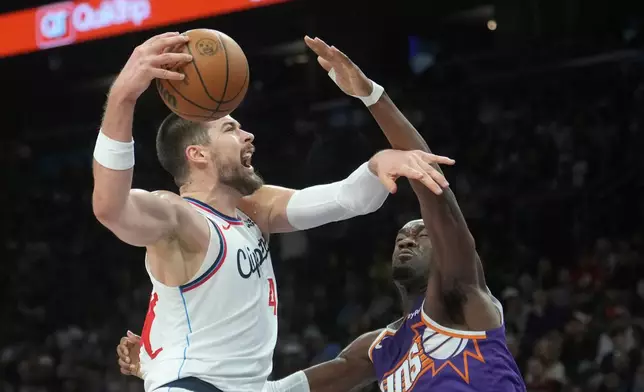 Los Angeles Clippers center Ivica Zubac, left, goes up for a shot against Phoenix Suns center Mark Williams, right, during the second half of an NBA basketball game Sunday, Feb. 1, 2026, in Phoenix. (AP Photo/Ross D. Franklin)