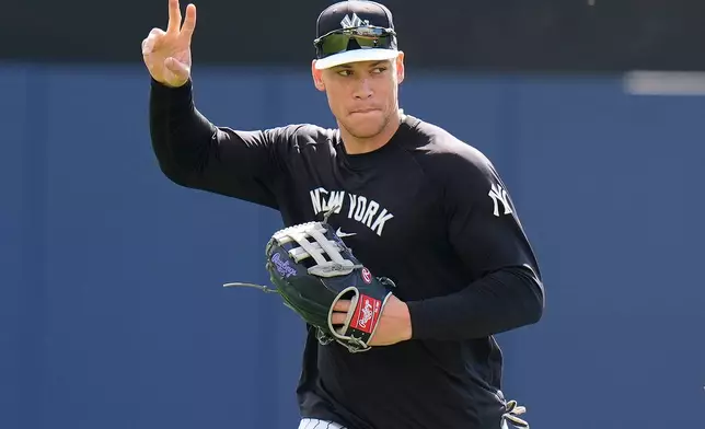 New York Yankees right fielder Aaron Judge waves to fans during a spring training baseball workout on Thursday, Feb. 12, 2026, in Tampa, Fla. (AP Photo/Chris O'Meara)