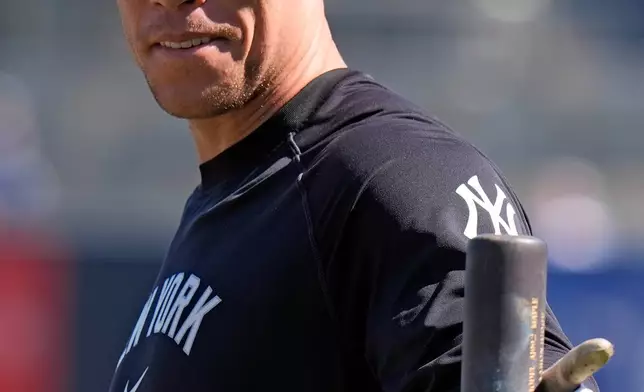 New York Yankees' Aaron Judge points at fans as he waits to take batting practice during a spring training baseball workout Friday, Feb. 13, 2026, in Tampa, Fla. (AP Photo/Chris O'Meara)