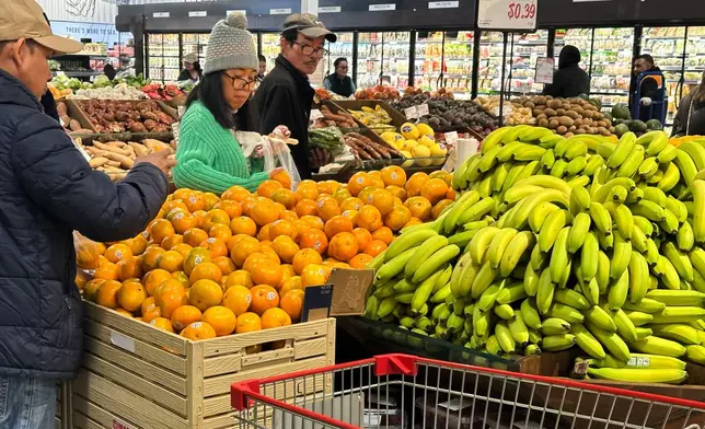 Shoppers shop at a grocery store in Schaumburg, Ill., Monday, Feb. 9, 2026. (AP Photo/Nam Y. Huh)
