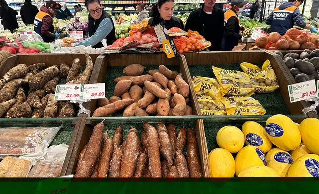 Shoppers shop at a grocery store in Schaumburg, Ill., Monday, Feb. 9, 2026. (AP Photo/Nam Y. Huh)