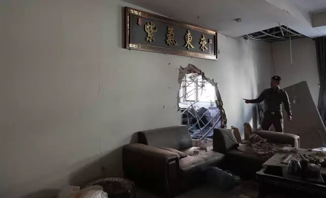 A Thai policeman inspects a scam compound in O'Smach, Cambodia, Monday, Feb. 2, 2026, (AP Photo/Sakchai Lalit)