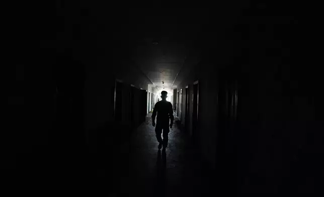 A Thai soldier walks at a at scam compound in O'Smach, Cambodia, Monday, Feb. 2, 2026, (AP Photo/Sakchai Lalit)