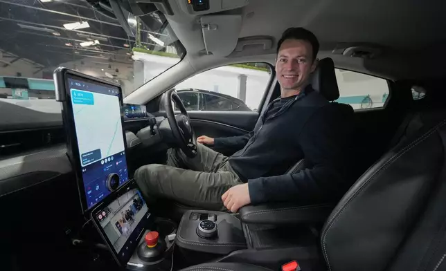 Britain Robotaxis Alex Kendall, co-founder and CEO of Wayve, sits in the autonomous vehicle during an interview in London, Monday, Feb. 9, 2026. (AP Photo/Kin Cheung)