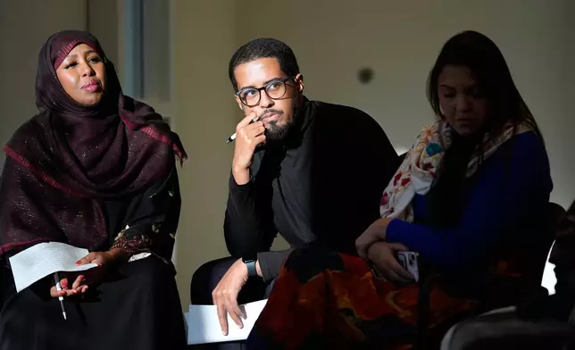Panelist Mirad Farah, left, and Emory University Ph.D. candidate Ahmed Haji Said, middle, lead a community discussion on vaccine education at Inspire Change Clinic, Nov. 22, 2025, in Minneapolis. (AP Photo/Abbie Parr)