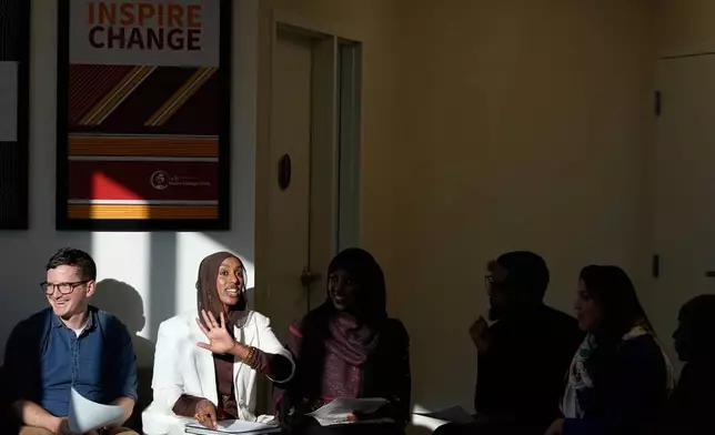 Dr. Bryan Fate, left, family nurse practitioner and CEO of Inspire Change Clinic Munira Maalimisaq, middle left, and panelist Mirad Farah, middle, lead a community discussion on vaccine education at Inspire Change Clinic, Nov. 22, 2025, in Minneapolis. (AP Photo/Abbie Parr)