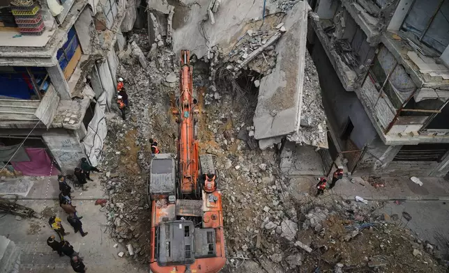 Gaza's civil defense teams work to recover the remains of members of the Abu Nada family, who remain buried beneath the rubble of their four-story house after it was destroyed by an Israeli airstrike in December 2023, in Gaza City, Monday, Feb. 9, 2026. (AP Photo/Jehad Alshrafi)