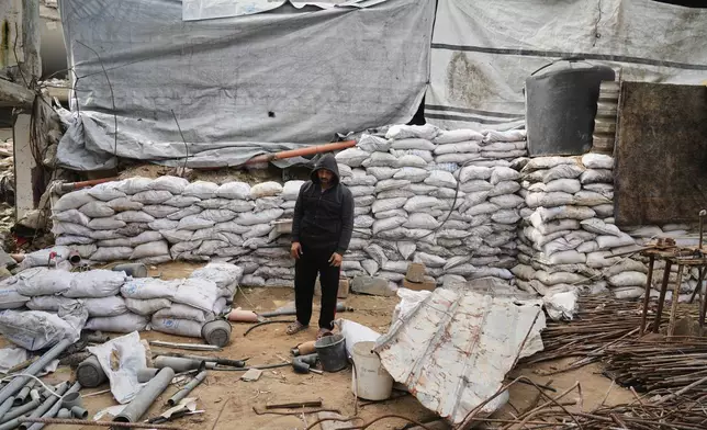 Mahmoud Hammad searching for the remains of relatives still buried beneath the rubble of their home, which was destroyed by an Israeli airstrike in December 2023, in Gaza City, Monday, Feb. 9, 2026. (AP Photo/Jehad Alshrafi)