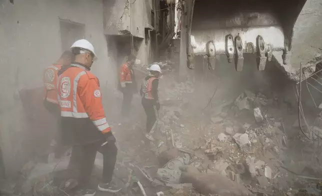 Gaza's civil defense teams work to recover the remains of members of the Abu Nada family, who remain buried beneath the rubble of their four-story house after it was destroyed by an Israeli airstrike in December 2023, in Gaza City, Monday, Feb. 9, 2026. (AP Photo/Jehad Alshrafi)