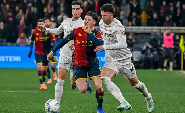 Genoa's Vitinha fights for the ball with Napoli's Amir Rrahmani, right, during the Serie A soccer match between Genoa and Napoli, Saturday, Feb. 7, 2026, in Genoa, Italy. (Tano Pecoraro/LaPresse via AP)