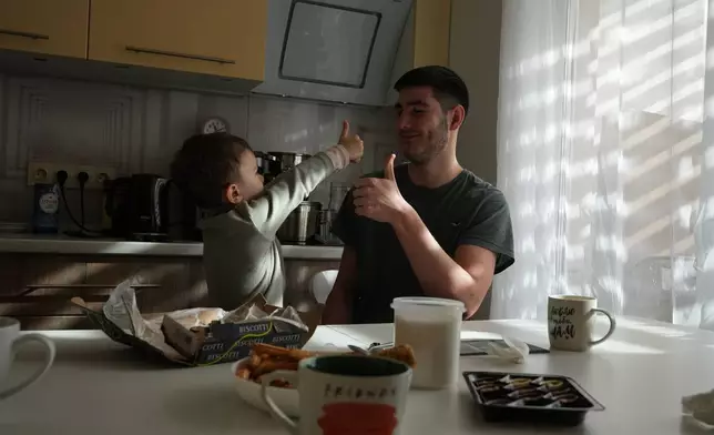 Davyd Osypenko, right, plays with his brother Hlib, 5, in Kyiv, Ukraine, Thursday, Feb. 19, 2026, nearly four years after their father was killed in a Russian airstrike. (AP Photo/Sergei Grits)