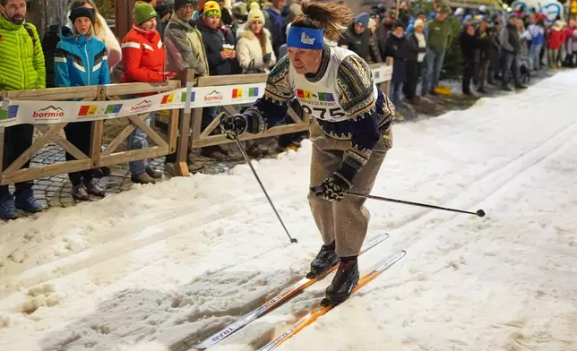 Bormio residents participate in an annual cross-country ski race through the streets of the old town, this year coinciding with the 2026 Winter Olympics, in Bormio, Italy, Friday, Feb. 13, 2026. (AP Photo/Rebecca Blackwell)