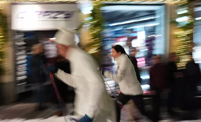 Bormio residents compete in an annual cross-country ski race through the streets of the old town, this year coinciding with the 2026 Winter Olympics, in Bormio, Italy, Friday, Feb. 13, 2026. (AP Photo/Rebecca Blackwell)