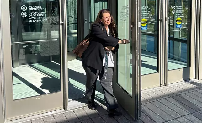 FILE - Heather Honey, a conservative election researcher, leaves the federal courthouse in Harrisburg, Pa., Oct. 18, 2024. (AP Photo/Mark Scolforo, file)