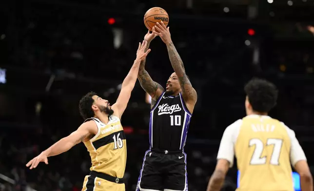 Sacramento Kings guard DeMar DeRozan (10) looks to shoot against Washington Wizards forward Anthony Gill (16) and guard Will Riley (27) during the second half of an NBA basketball game, Sunday, Feb. 1, 2026, in Washington. (AP Photo/Nick Wass)
