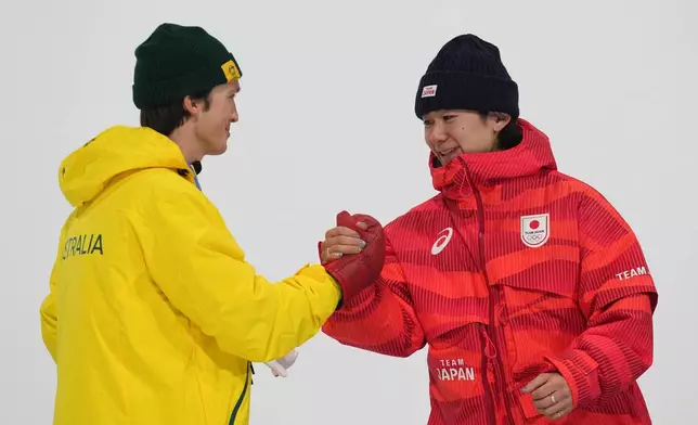 Silver medalist Australia's Scotty James, left, celebrates with gold medalist Japan's Yuto Totsuka after the men's snowboarding halfpipe finals at the 2026 Winter Olympics, in Livigno, Italy, Friday, Feb. 13, 2026. (AP Photo/Gregory Bull)