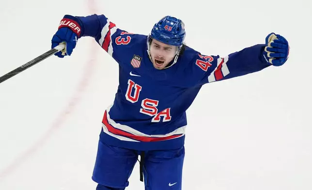 United States' Quinn Hughes celebrates after scoring the winning goal against Sweden during the overtime period of a men's ice hockey quarterfinal game at the 2026 Winter Olympics, in Milan, Italy, Wednesday, Feb. 18, 2026. (AP Photo/Hassan Ammar)