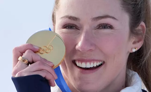 United States' Mikaela Shiffrin celebrates winning the gold medal in an alpine ski, women's slalom race, at the 2026 Winter Olympics, in Cortina d'Ampezzo, Italy, Wednesday, Feb. 18, 2026. (AP Photo/Jacquelyn Martin)