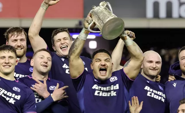 Scotland's Sione Tuipulotu lifts the Calcutta Cup after winning the Six Nations rugby union match between Scotland and England in Edinburgh, Scotland, Saturday Feb. 14, 2026. (Steve Welsh/PA via AP)