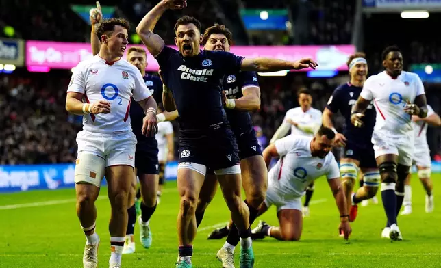 Scotland's Ben White celebrates scoring a try during the Six Nations rugby union match between Scotland and England in Edinburgh, Scotland, Saturday Feb. 14, 2026. (Jane Barlow/PA via AP)
